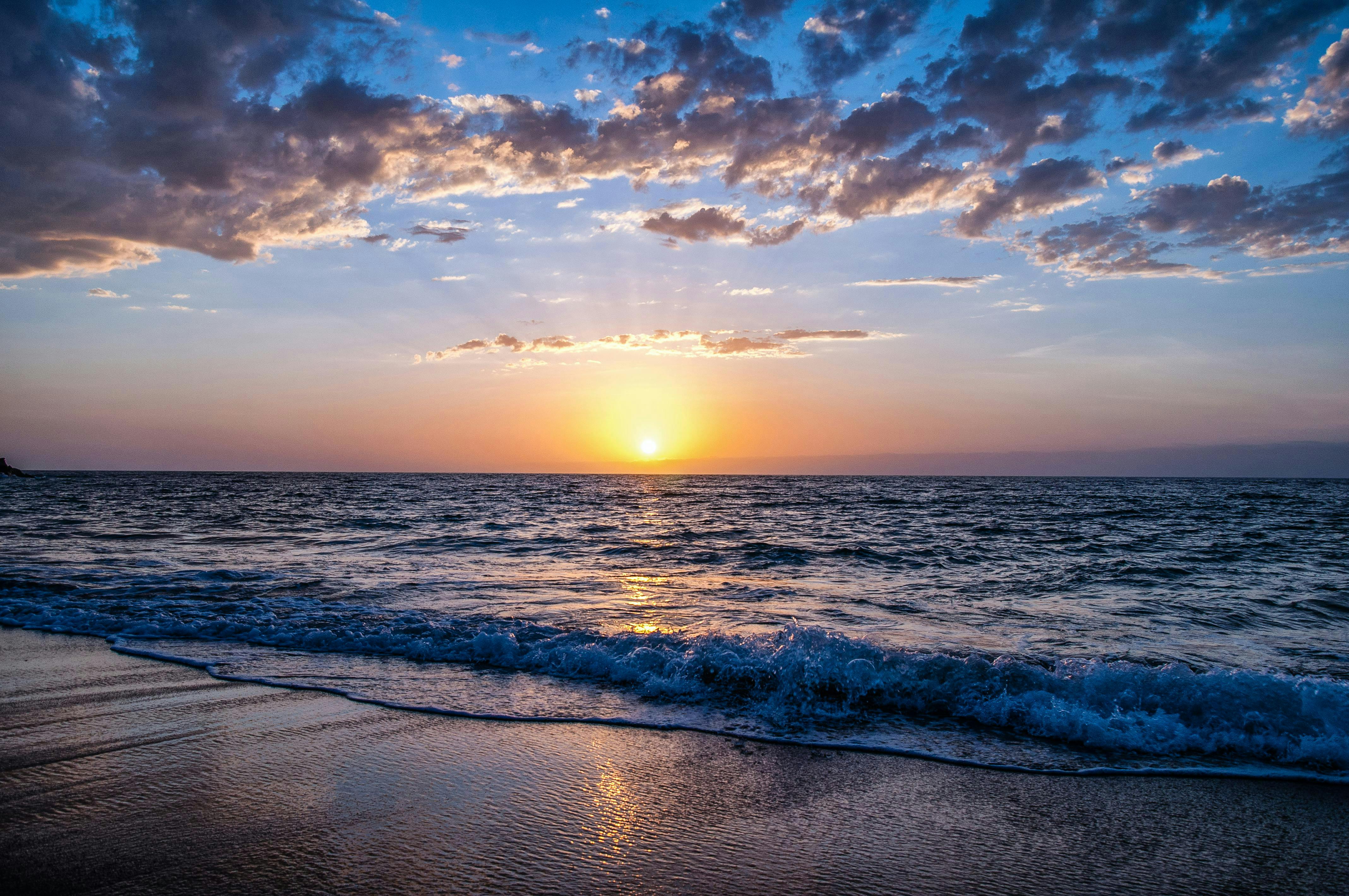 A beach with water flowing up onto the shoreline