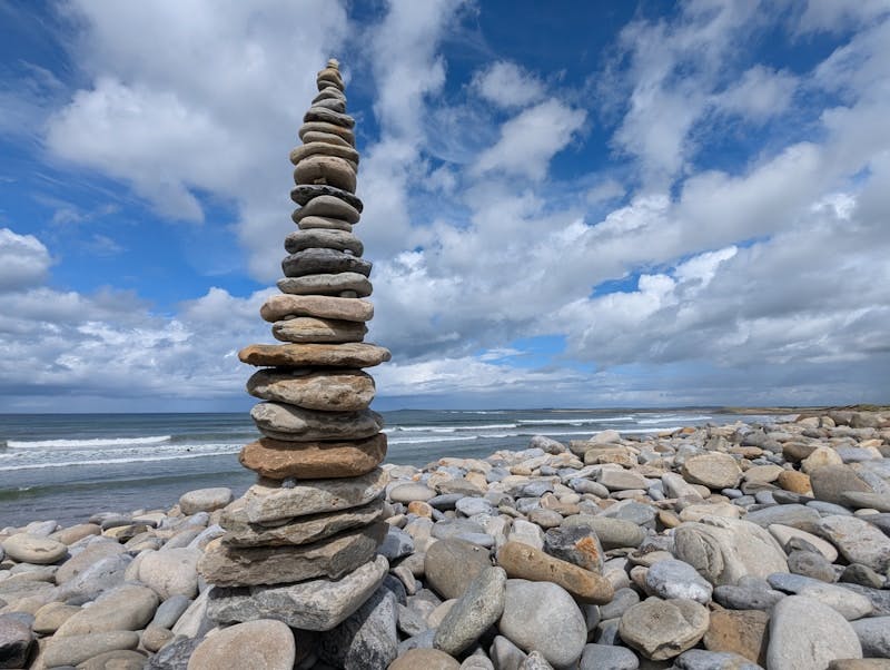 Stones balancing on top of one another on a beach