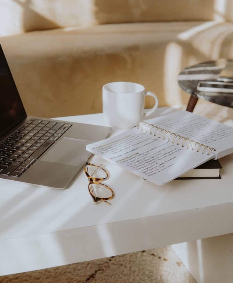 white ceramic mug on white table