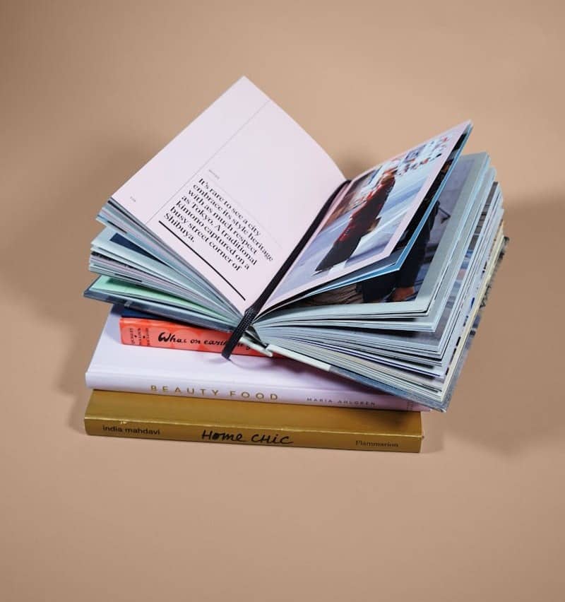 open book on top of several stacked books