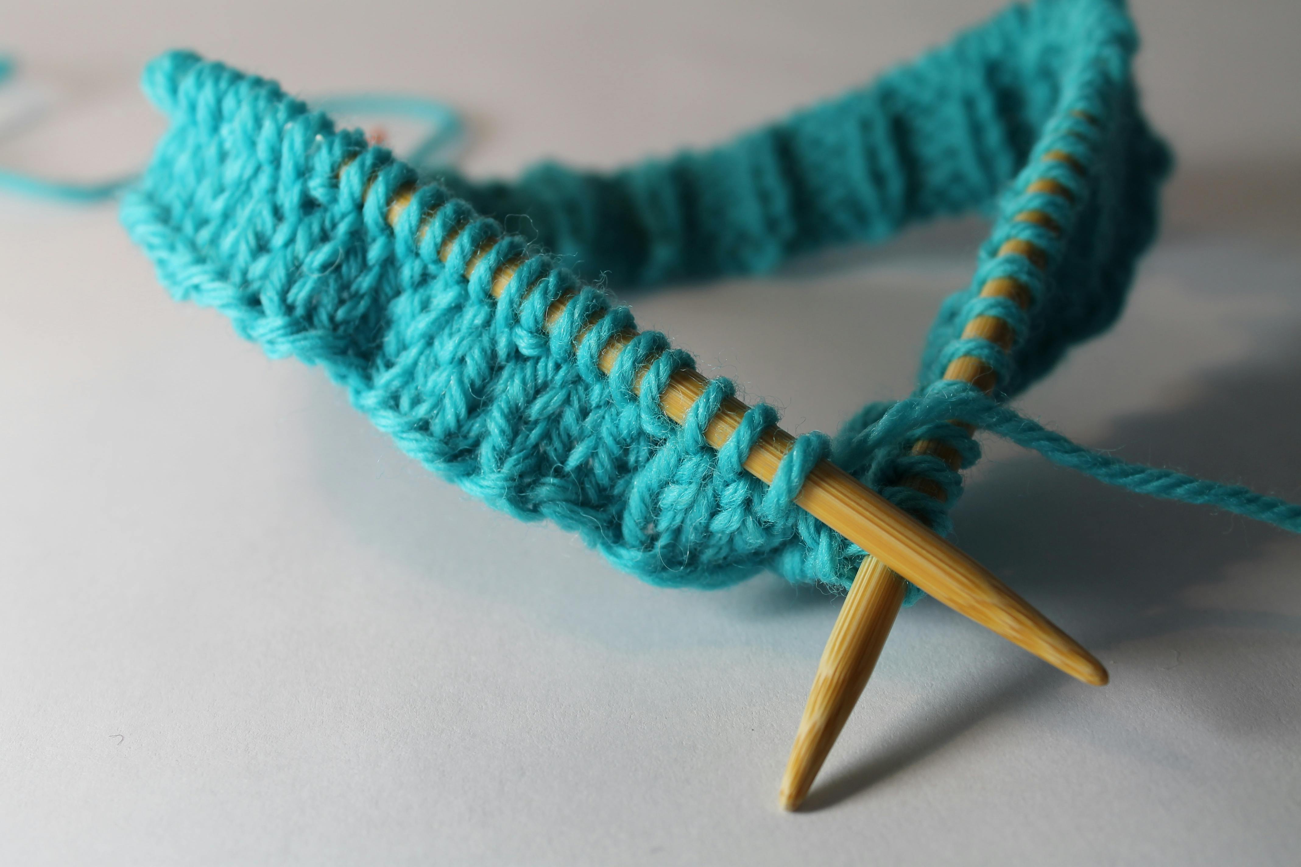 knitting needles and turquoise yarn