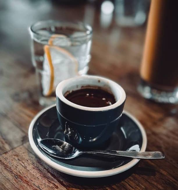 A cup of coffee sitting on top of a wooden table