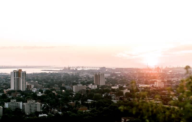City skyline at sunset with distant water view