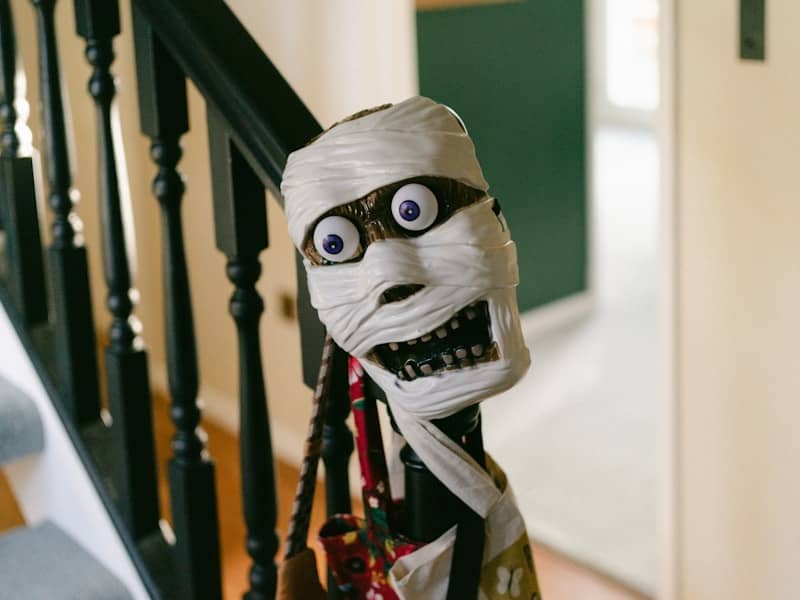 Mummy decoration with googly eyes on staircase