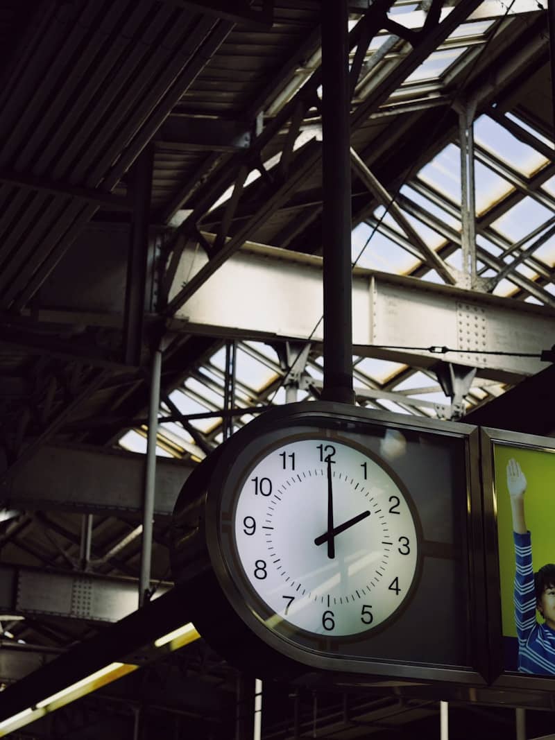 Large clock hanging in a train station