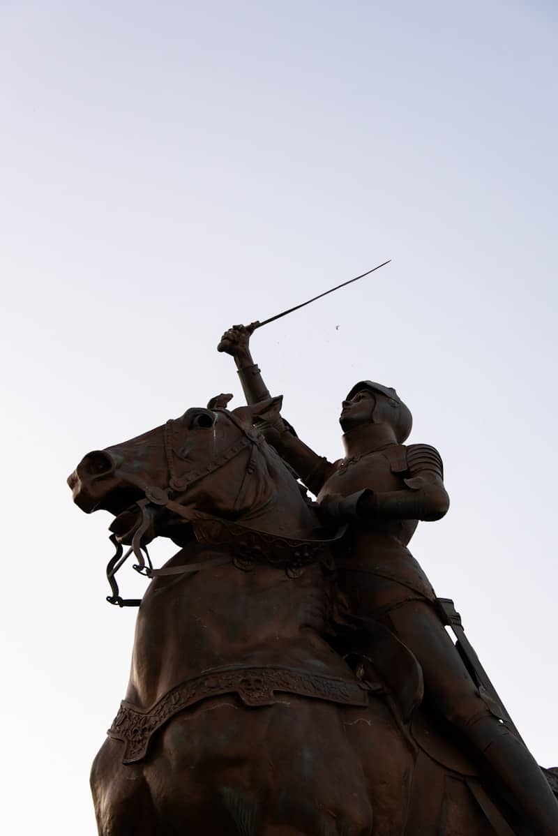 Statue depicts joan of arc on horseback.