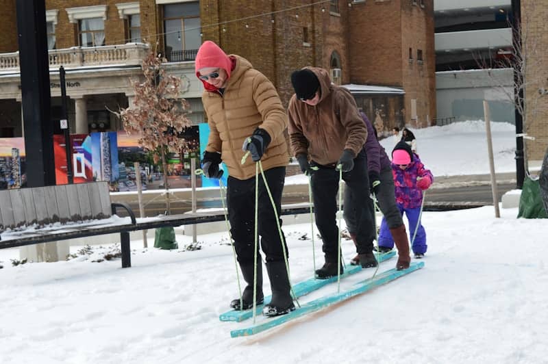 People sledding together on a snowy day