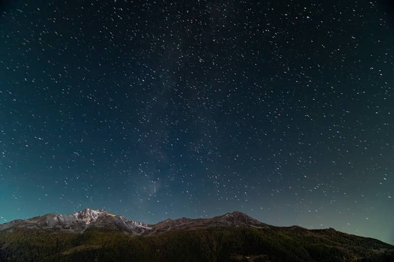 Starry night sky over majestic mountains