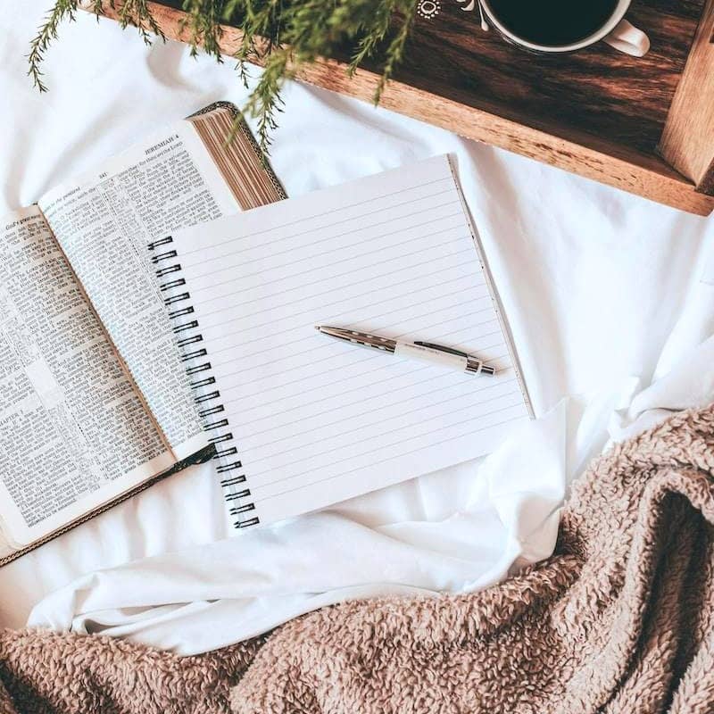 white notebook on white textile