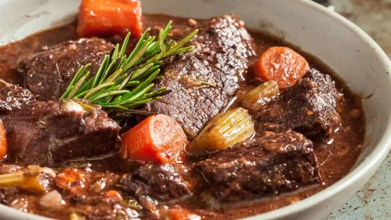 A bowl of beef stew with vegetables.