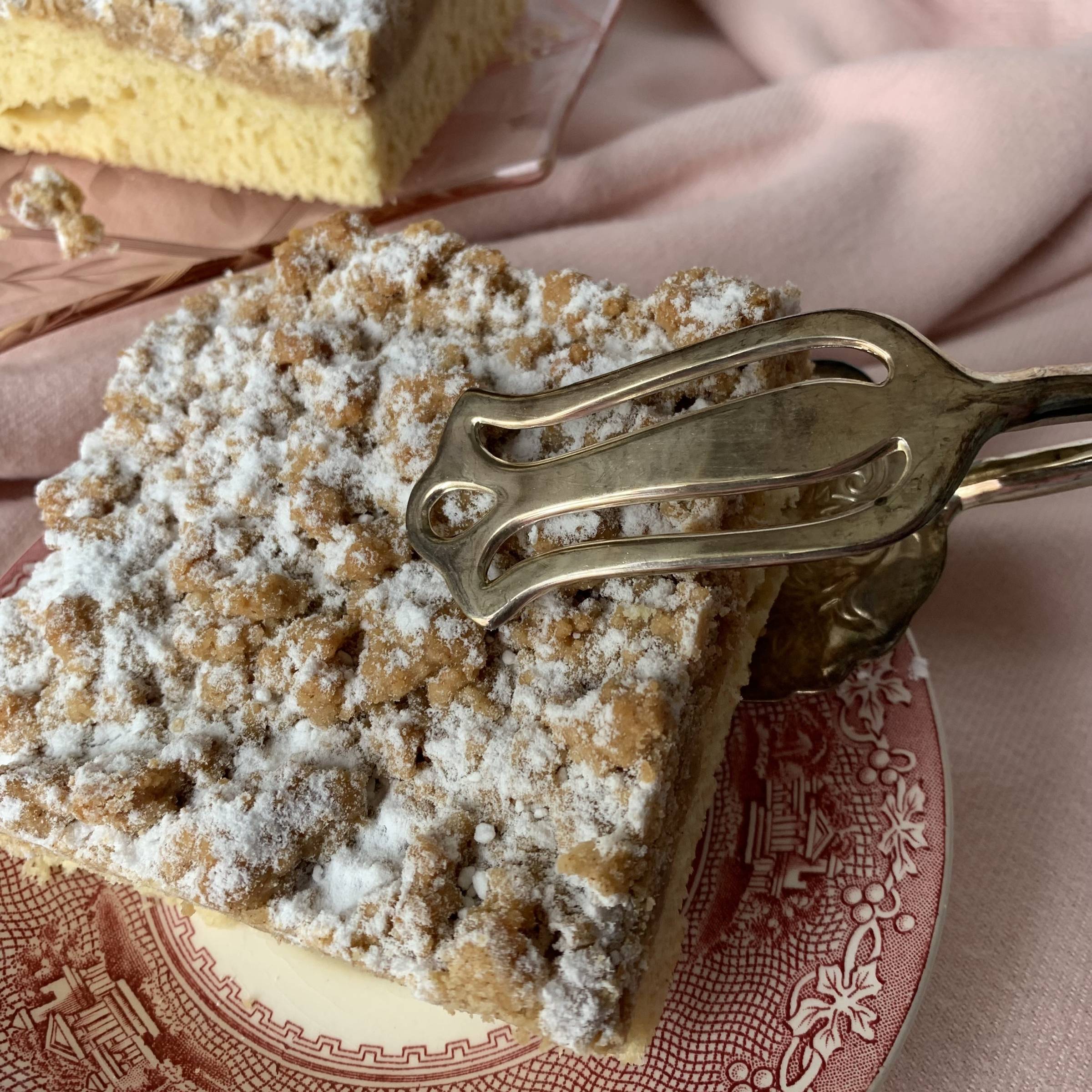 New York Crumb Cake has been a beloved classic since 1898, earning its place as the ultimate companion to a hot cup of coffee. For many of us, it’s more than just cake—it’s a bite of nostalgia. I still remember the chaos of our neighborhood bakery: the wa