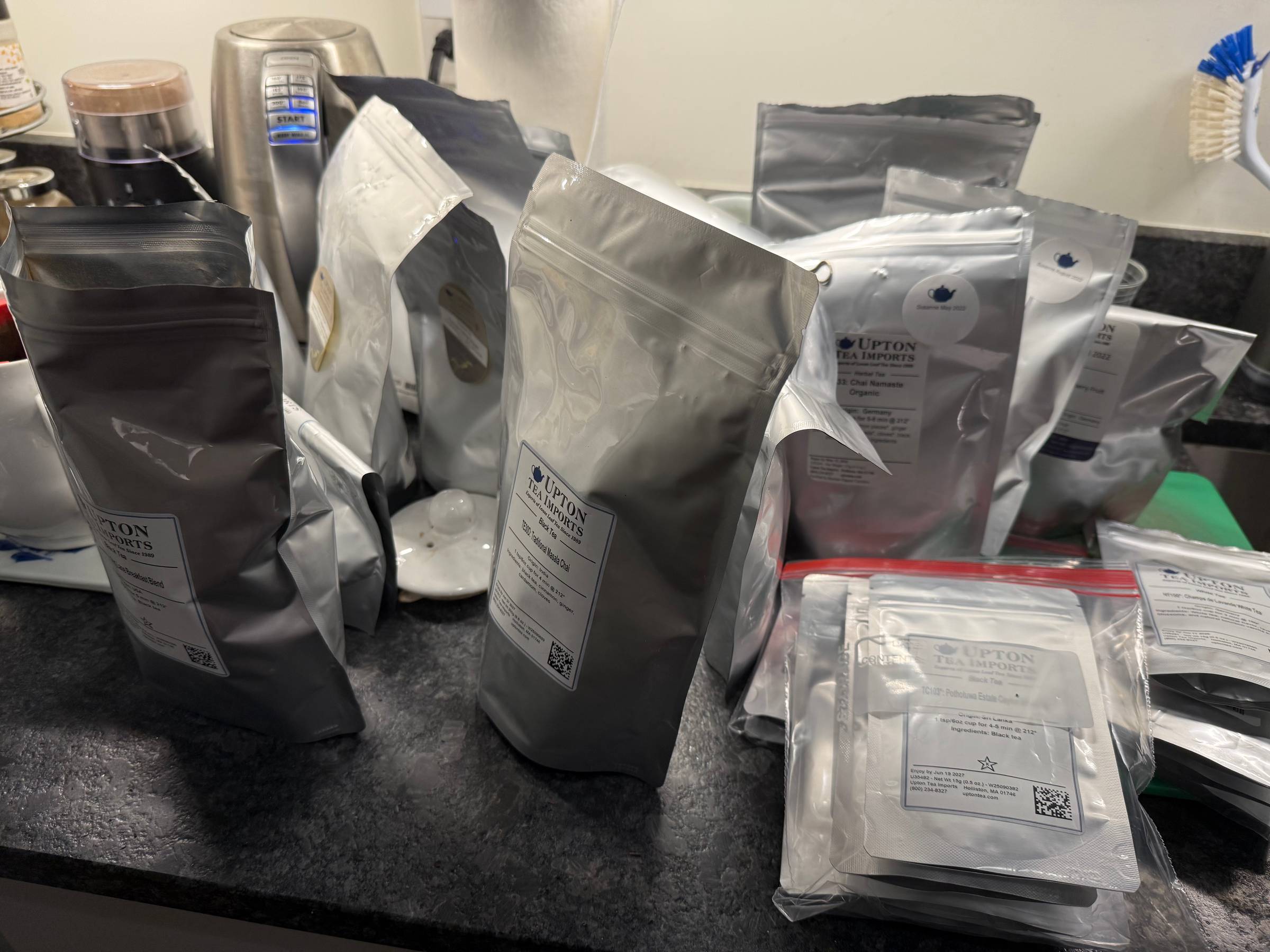 My kitchen counter covered with silver packages of tea