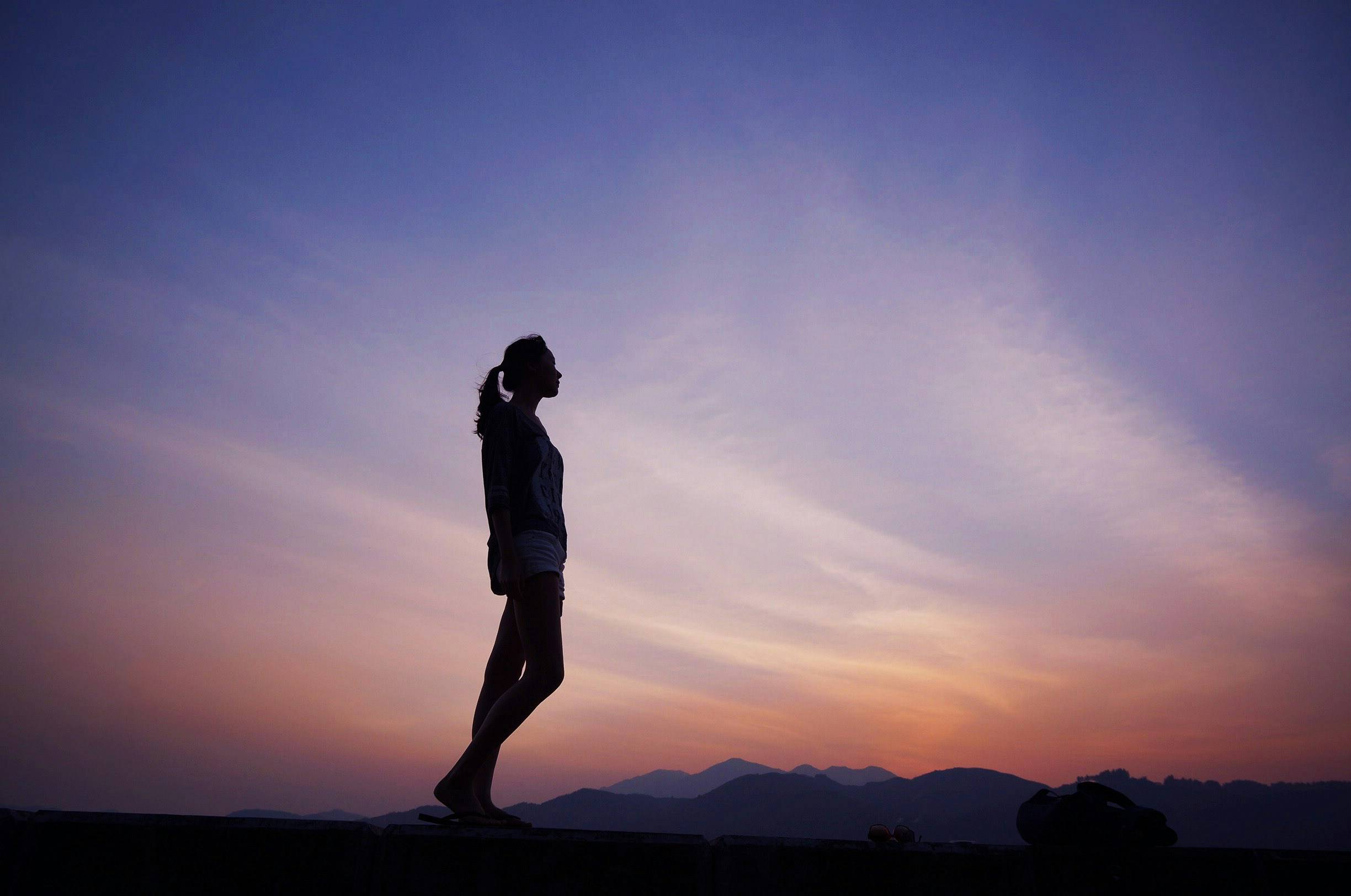 A woman walking at sunset