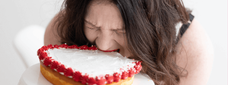 Emily biting into a heart shaped cake!
