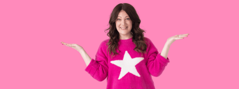 Emily wearing a hot pink sweater with a white star on it.