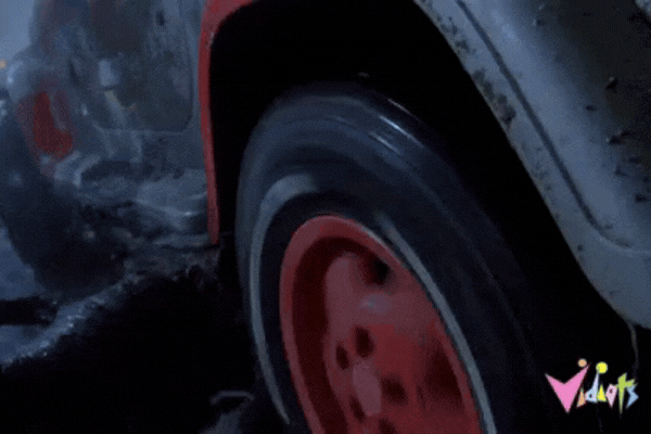 Short video of vehicle stuck in the mud with tyre spinning.
