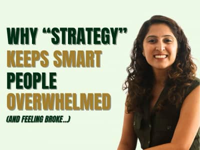 Bold text reading “Why ‘Strategy’ Keeps Smart People Overwhelmed (and feeling broke…)” beside a smiling woman seated on a light background.