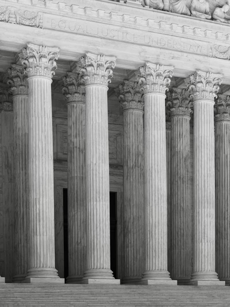 A row of classical fluted columns with ornate capitals.