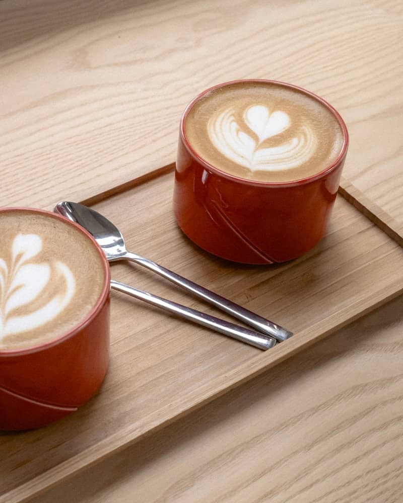 Two lattes with beautiful latte art.