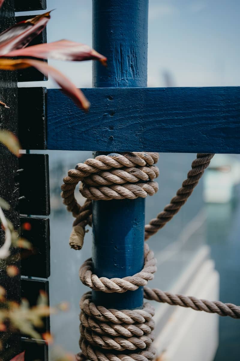 Thick rope tied around a blue post