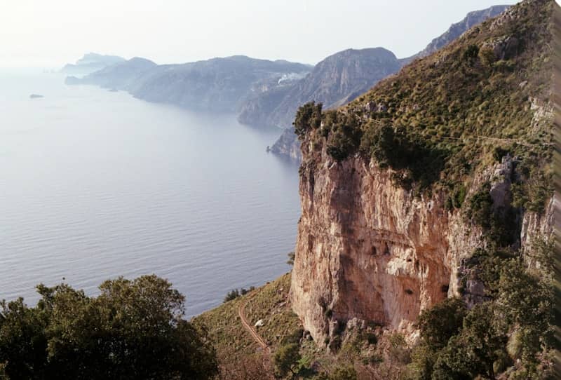 Rocky cliff overlooking a serene ocean bay