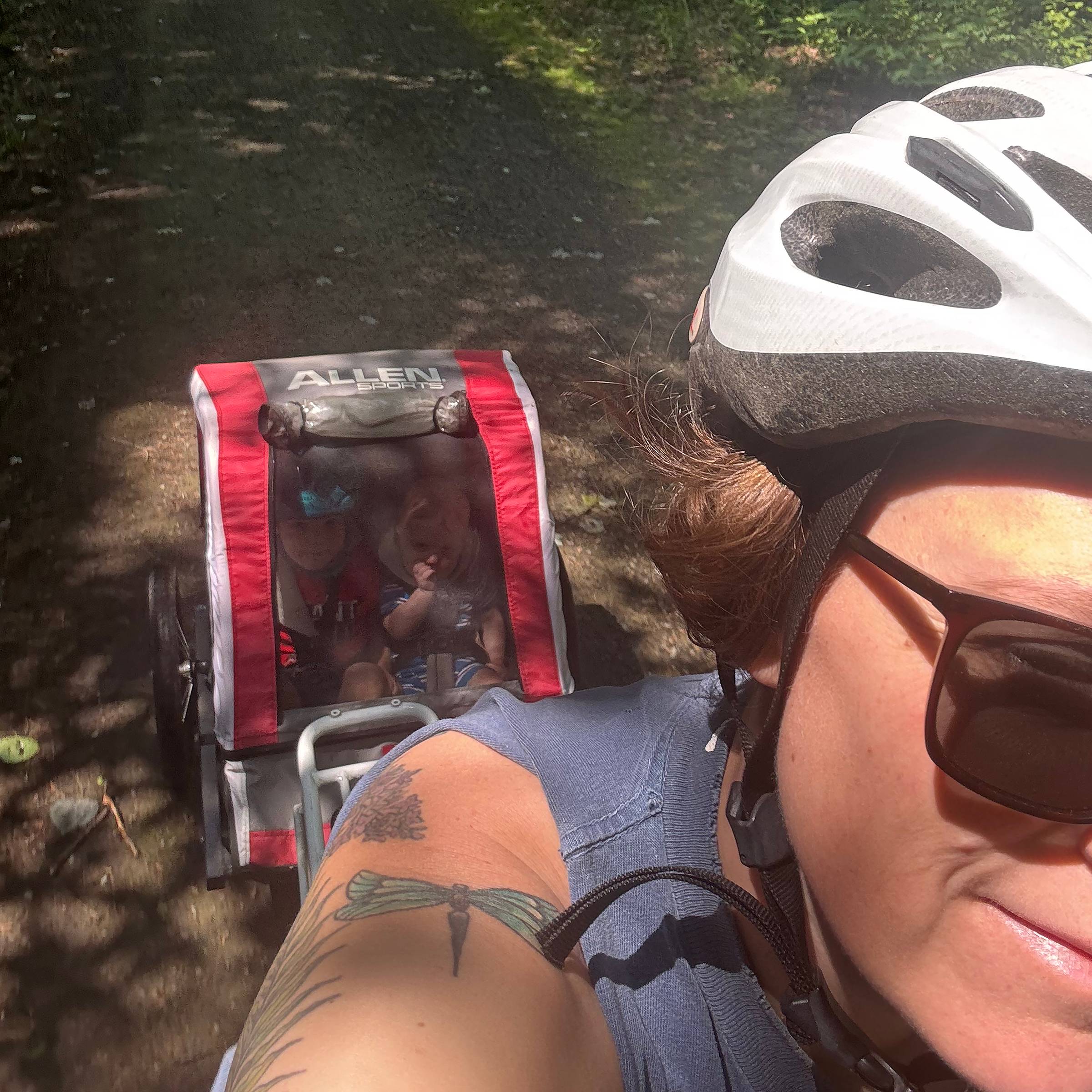 Erin on a bike ride with kids in tow.