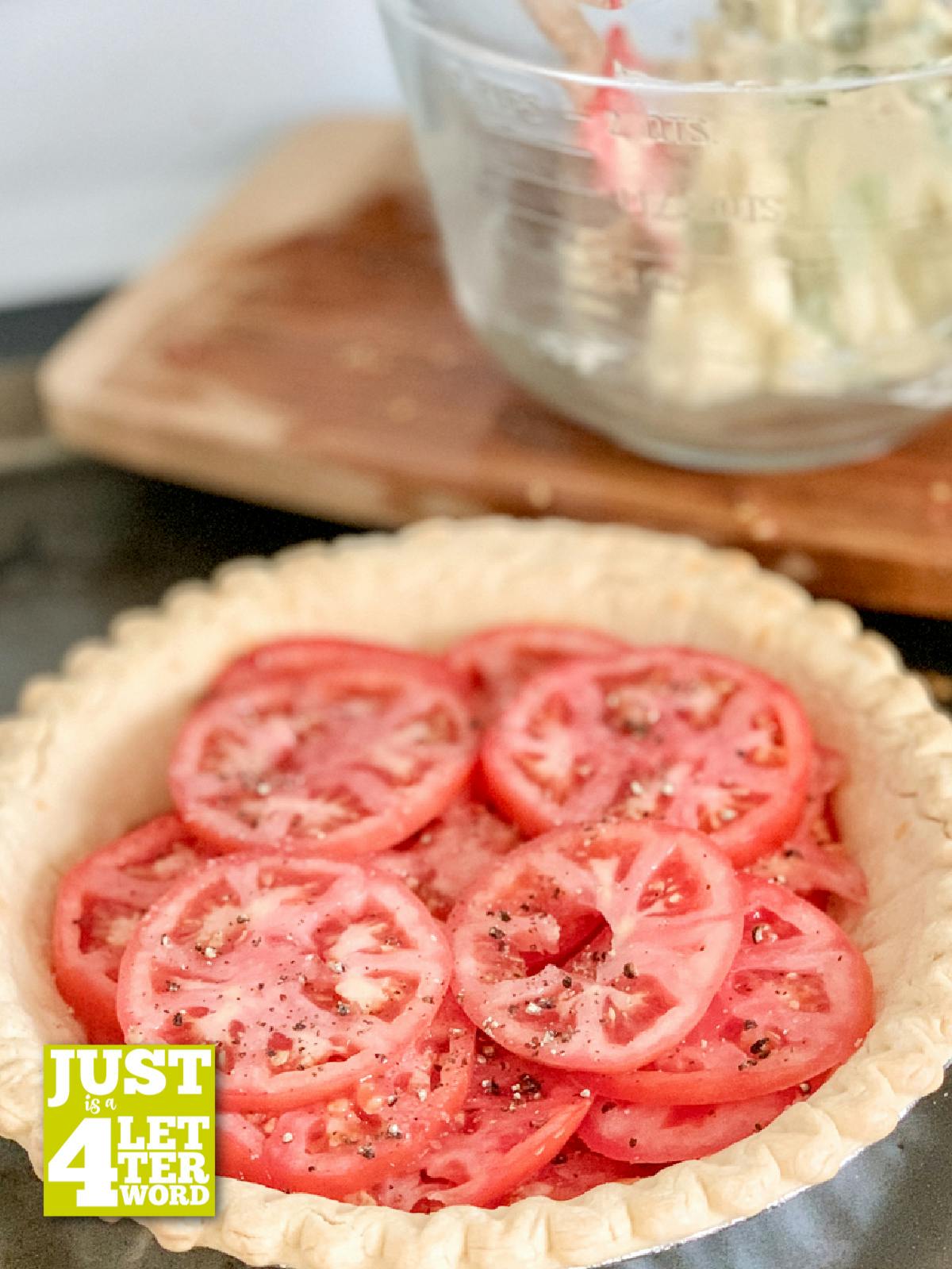 Sliced tomatoes in an unbaked pie crus