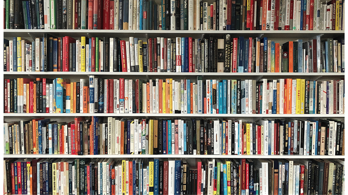 image of my personal bookshelf, 5 shelves filled top to bottom