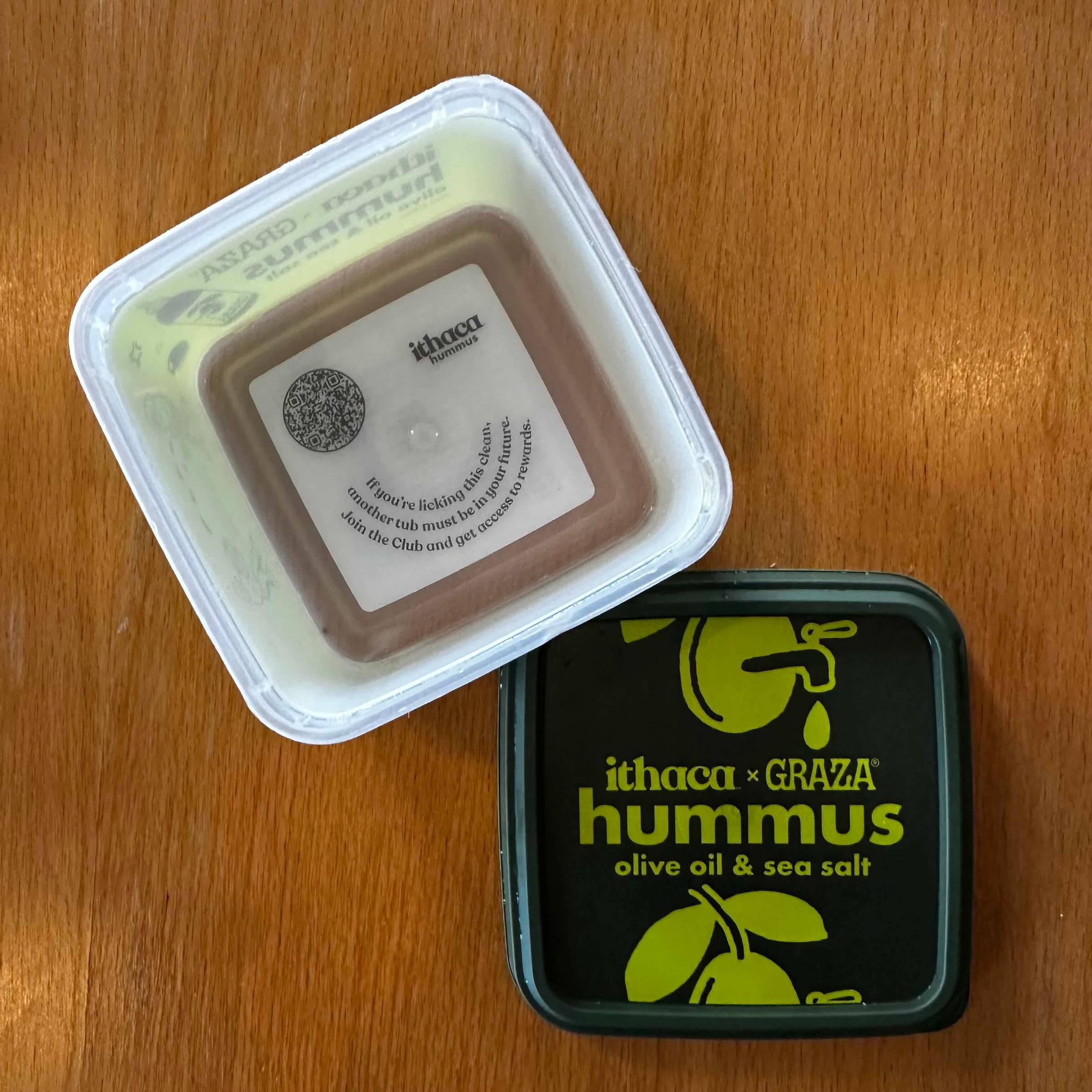 Image of empty tub of Ithaca Hummus, showing message at bottom of tub.