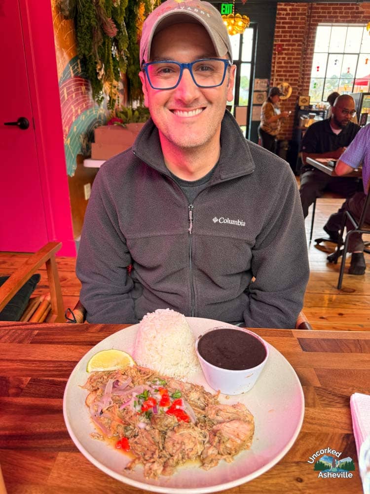 Tom eating Guajiro pork, rice, and beans Asheville NC