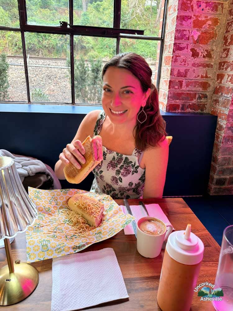 Christine eating Guajiro Cuban Sandwich Asheville NC