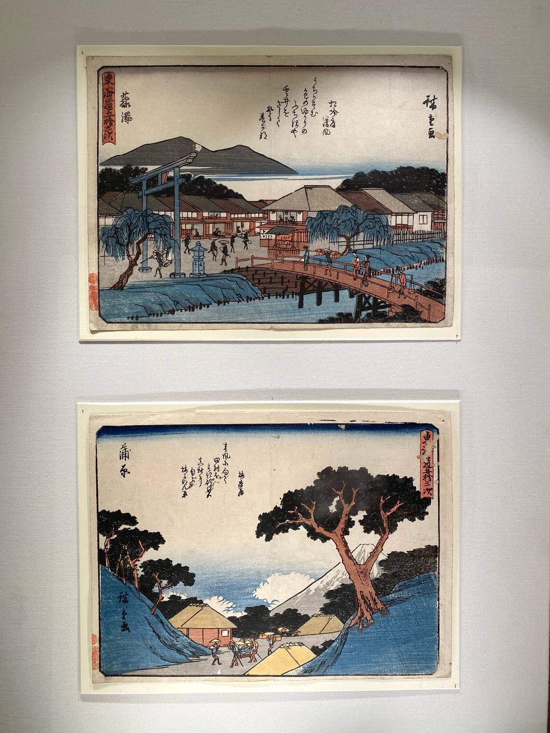 2 Japanese woodcuts depicting nature and village scenery.