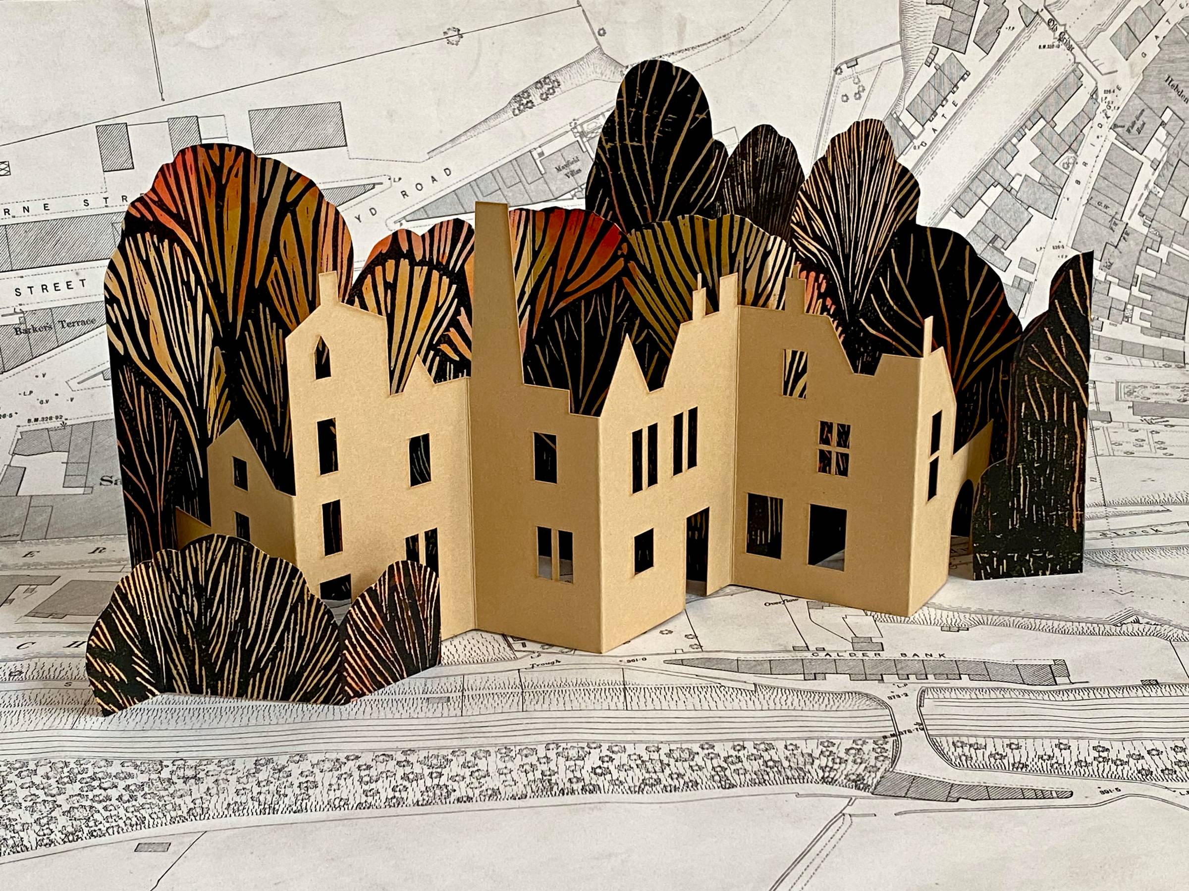 Miniature paper sculpture of Hebden Bridge photographed on an 1891 map of the town.