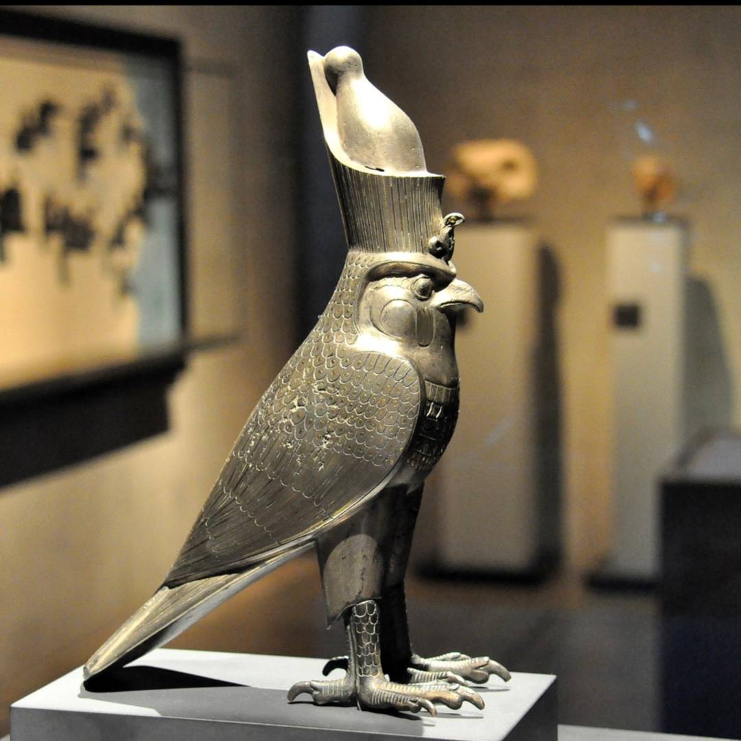 ancient Egyptian Horus as falcon statuette in museum setting