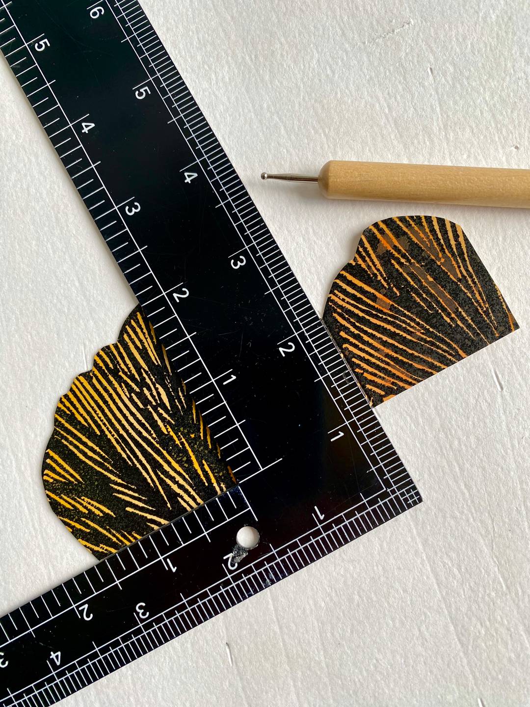 a bookbinders square, a ball-burnisher and some card artwork.