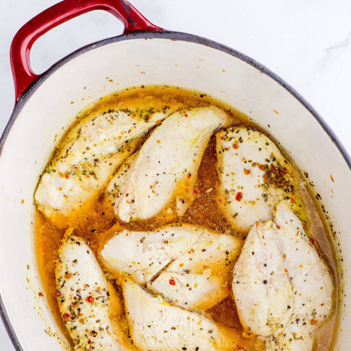 chicken breasts cooked in a dutch oven ready to be diced for easy convient meal prep chicken