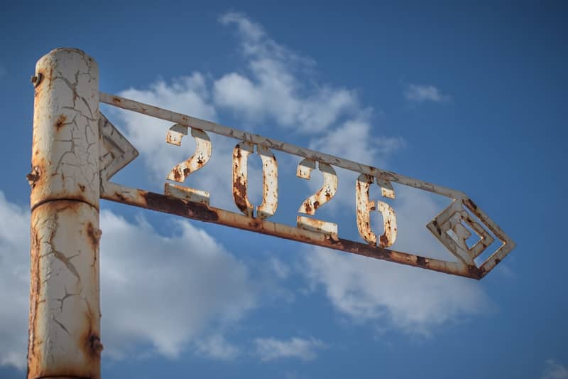 Rusty signpost with the number 2026 against sky