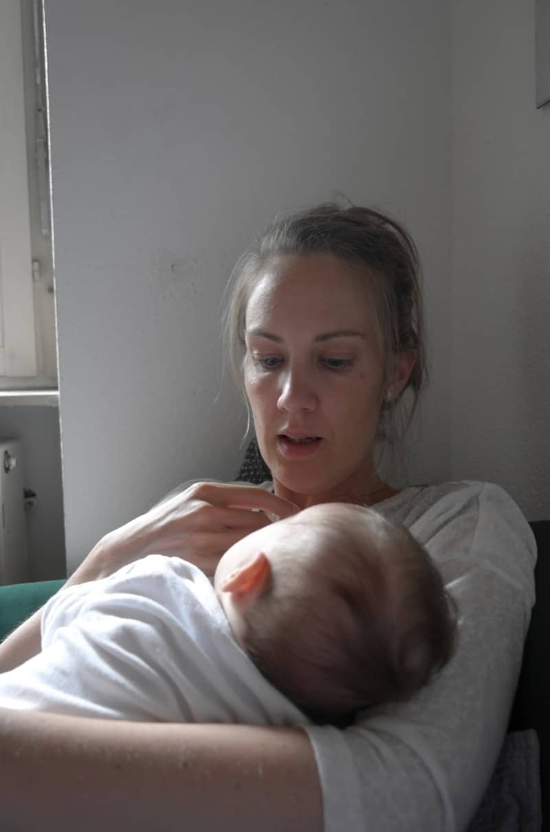 Mother lovingly breastfeeds her baby.