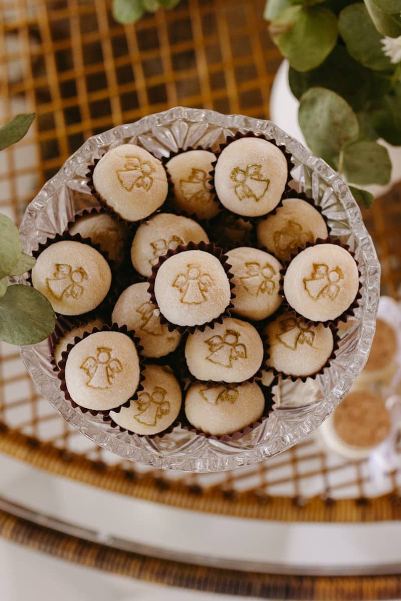 Crystal bowl filled with white angel-stamped candies.