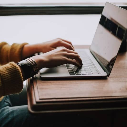 person sitting front of laptop