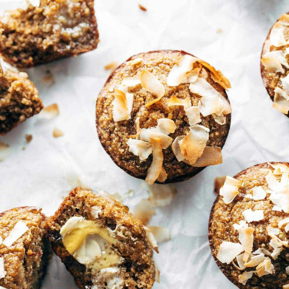 Feel-Good Apple Muffins drizzled with honey and covered in flaked coconut