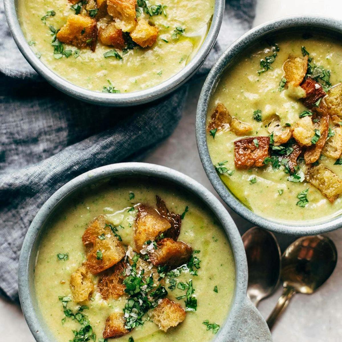 Broccoli cheese soup in bowls with croutons on top