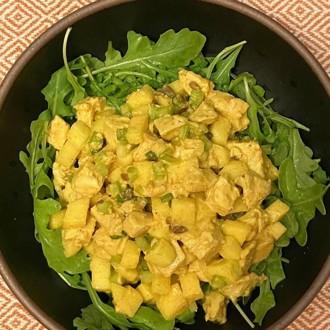 Curry chicken salad over salad greens