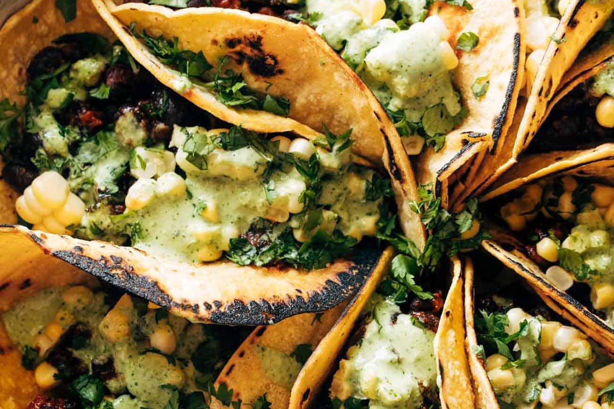 Smoky Beans and Greens Tacos in a circular pattern on a plate