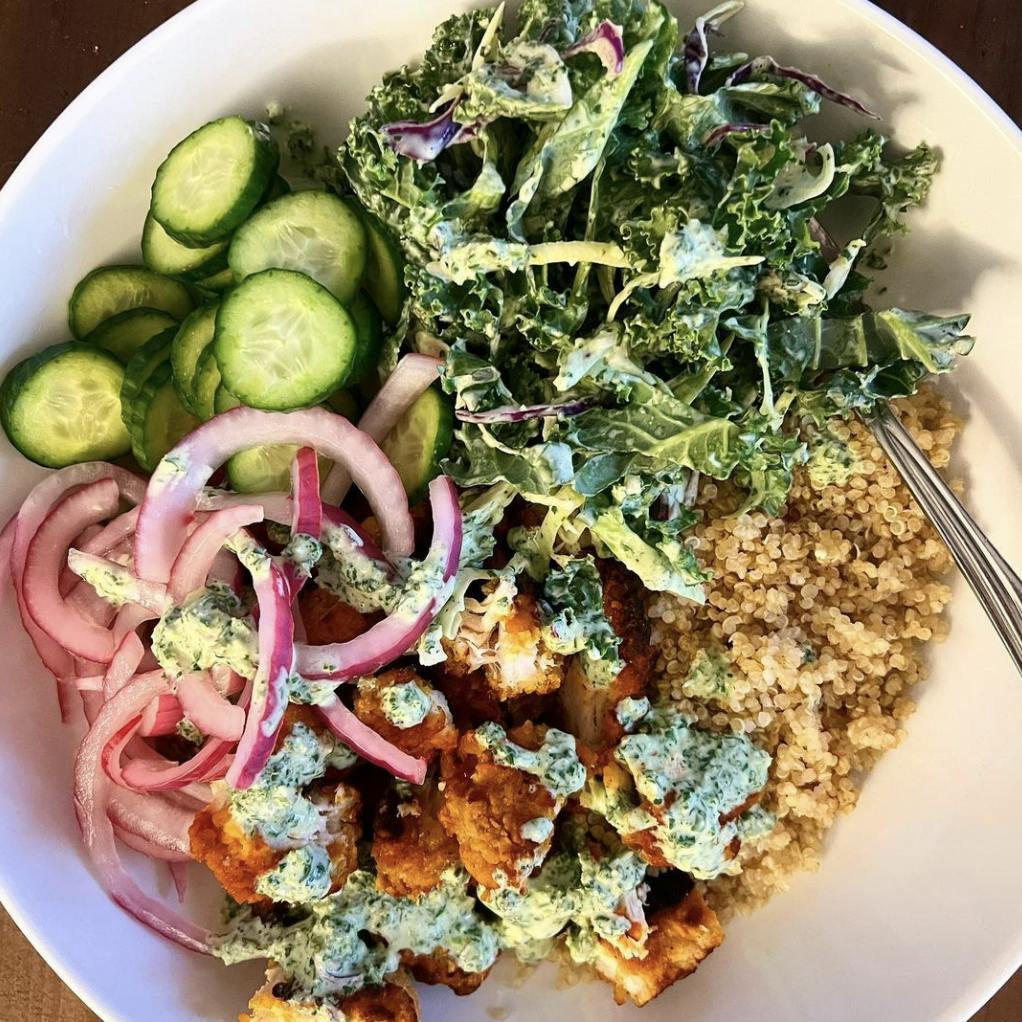 Bowls with crispy chicken tikka, quinoa, and fresh veggies.