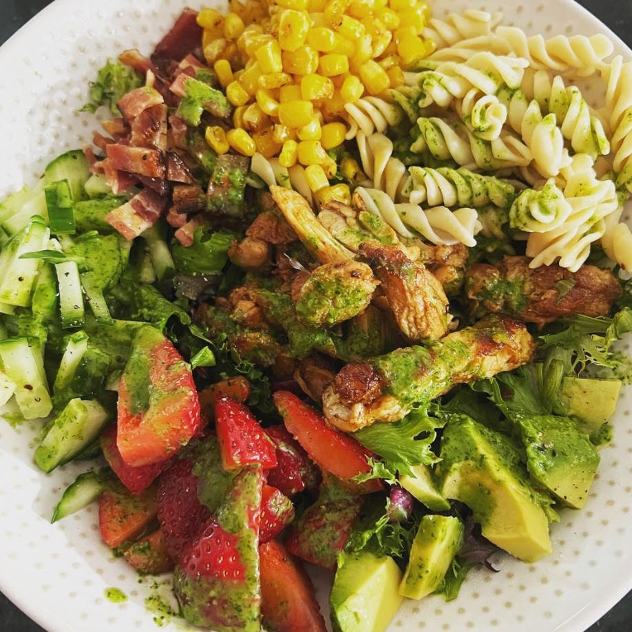 Chipotle chicken cobb salad in a bowl with pasta.