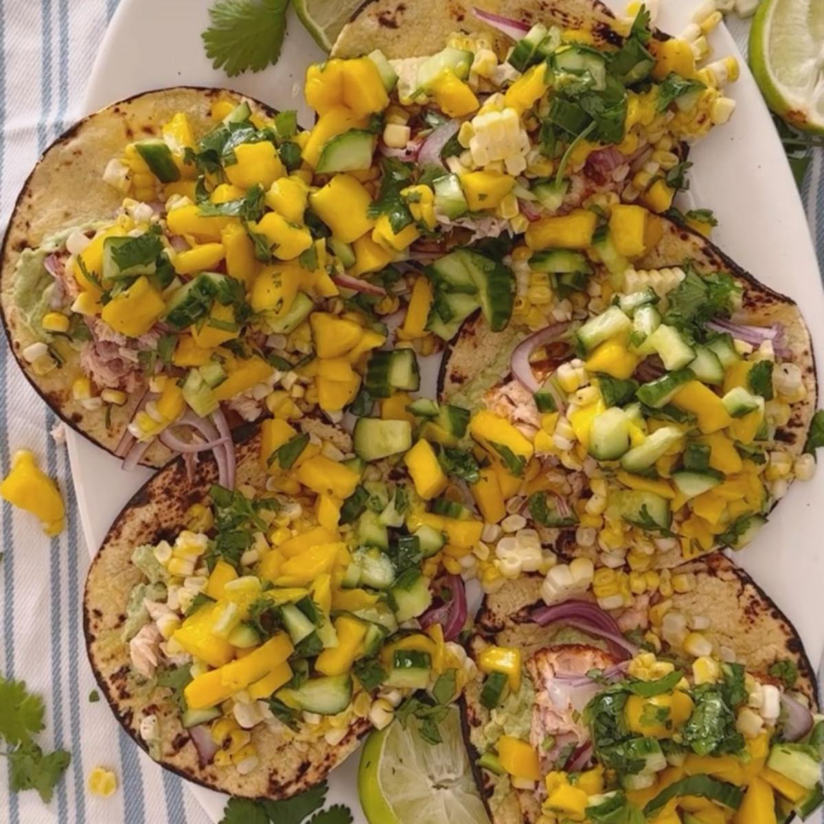 Salmon tacos on a plate with mango salsa