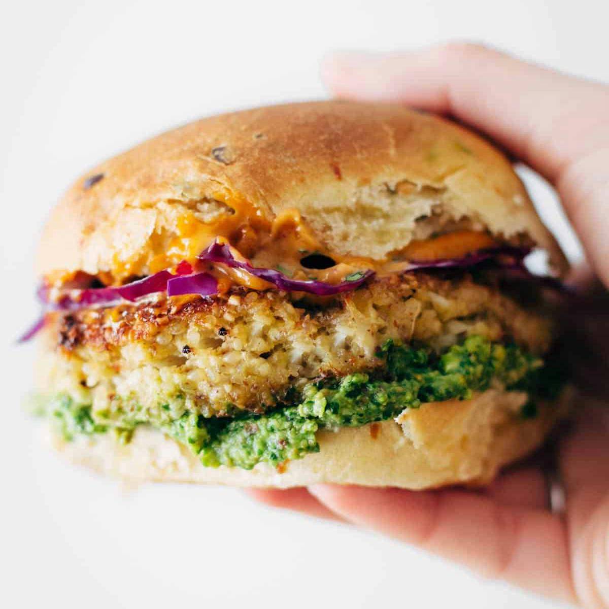 Cauliflower burgers with avocado sauce, chipotle mayo, and slaw on a bun