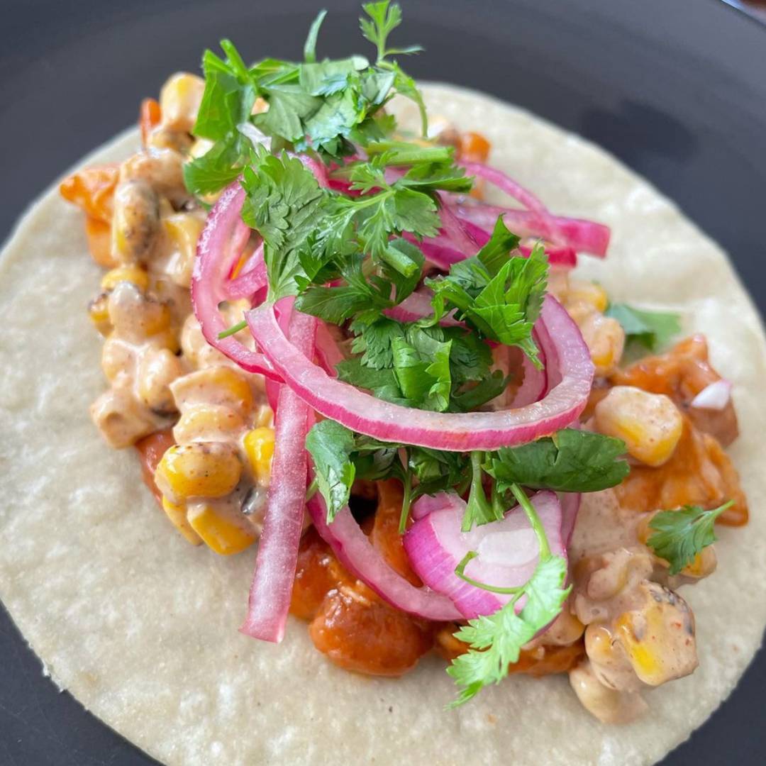 Chicken tacos with red onions and cilantro.