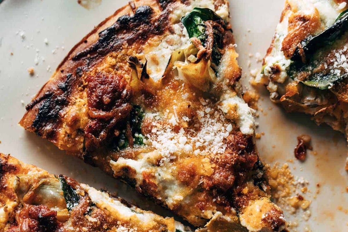 The Absolute Easiest Spinach and Artichoke Pizza on a plate